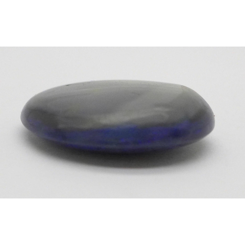 990 - An unmounted black opal, over 47 carats, 26mm x 32mm