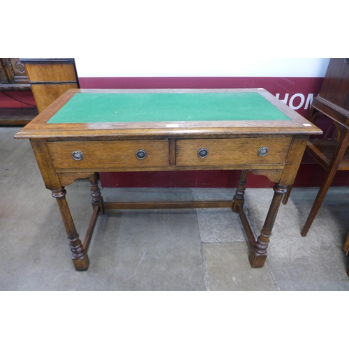 1 - An Edward VII oak two drawer writing table