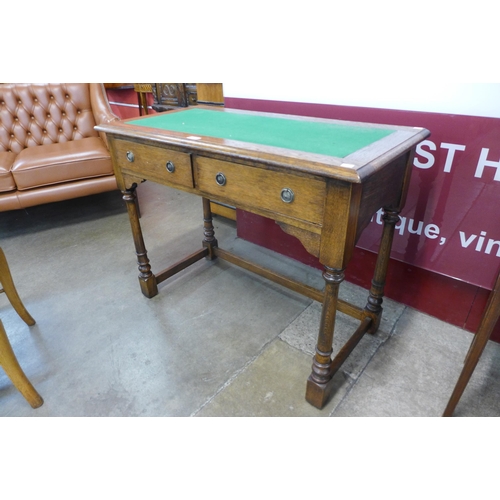 1 - An Edward VII oak two drawer writing table