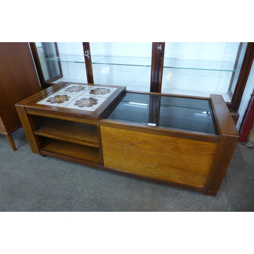 100 - A teak, glass and tiled topped coffee table