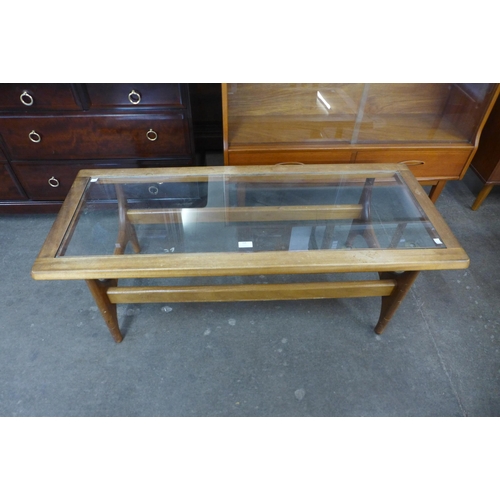 104 - A Stonehill Stateroom teak and glass topped coffee table