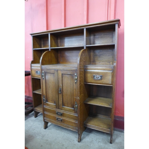 12 - An Arts and Crafts oak open breakfront bookcase