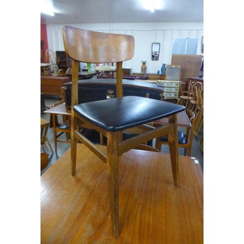 121 - A teak extending dining table and four chairs