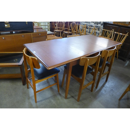 122 - A teak extending dining table and six chairs