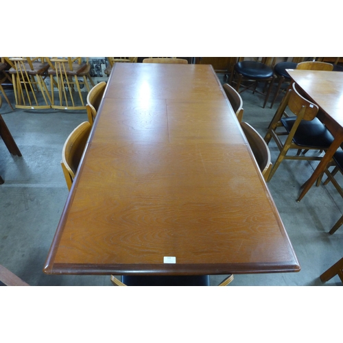 122 - A teak extending dining table and six chairs