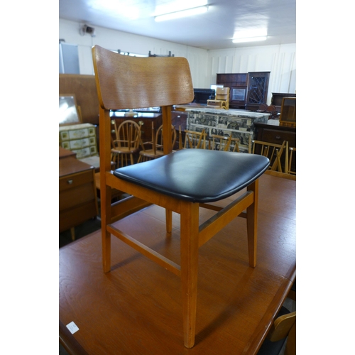 122 - A teak extending dining table and six chairs