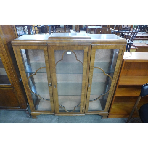 136 - A walnut three door display cabinet