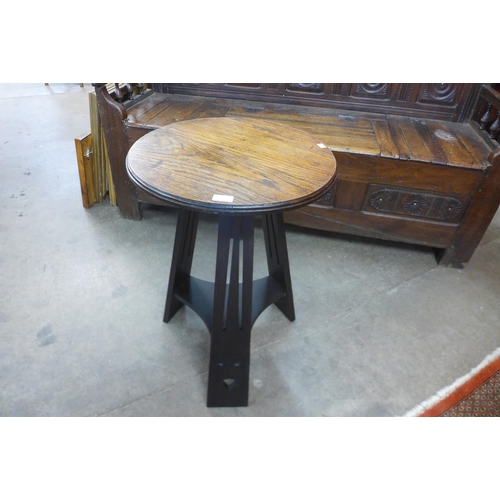 14 - An Arts and Crafts oak circular occasional table