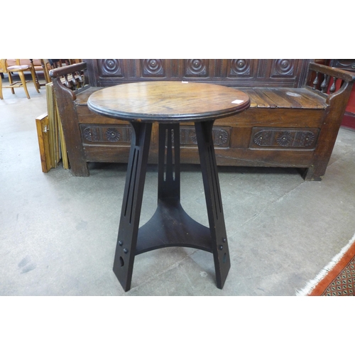 14 - An Arts and Crafts oak circular occasional table