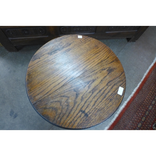 14 - An Arts and Crafts oak circular occasional table