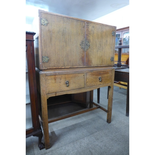 141 - An oak two door cupboard on stand