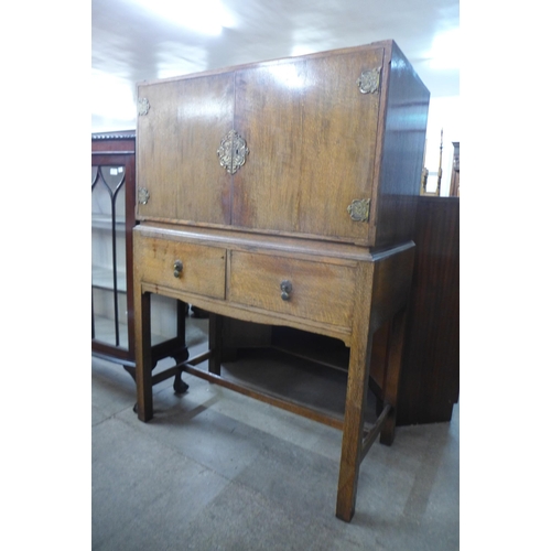 141 - An oak two door cupboard on stand