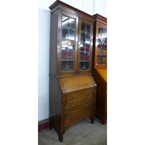 145 - An early 20th Century oak and stained glass bureau bookcase