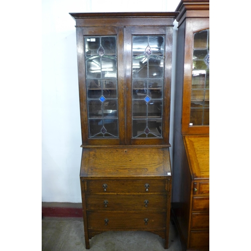 145 - An early 20th Century oak and stained glass bureau bookcase