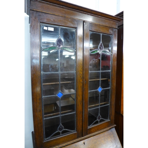 145 - An early 20th Century oak and stained glass bureau bookcase