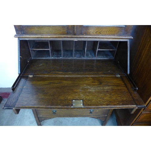 145 - An early 20th Century oak and stained glass bureau bookcase