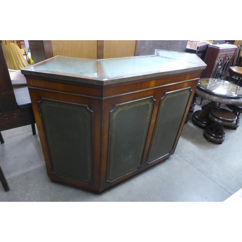 147 - A mahogany and green leather panelled bar