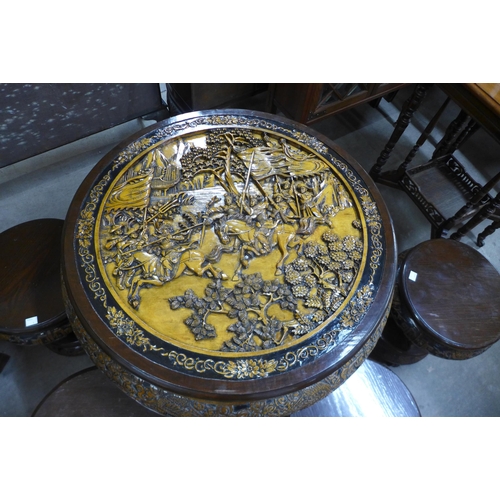 148 - An eastern carved hardwood circular table and four stools