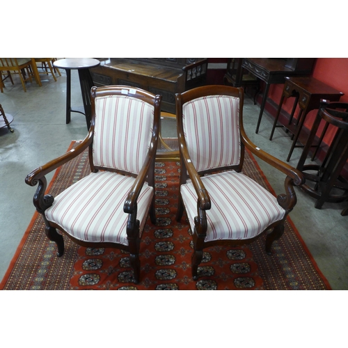 16 - A pair of 19th Century French Empire style mahogany and upholstered fauteuils