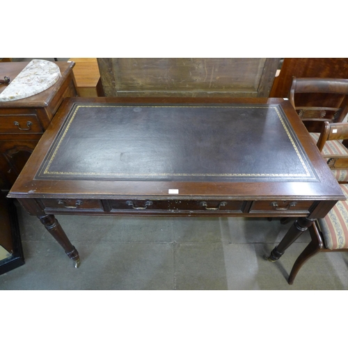 202 - A mahogany six drawer writing table