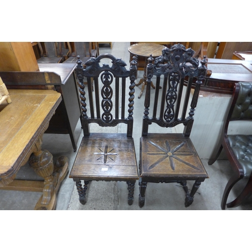 210 - Two Victorian Jacobean Revival carved oak hall chairs