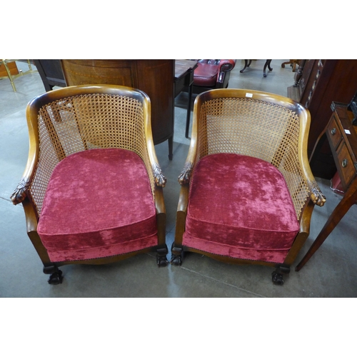 30 - A pair of 1930's carved walnut bergere armchairs