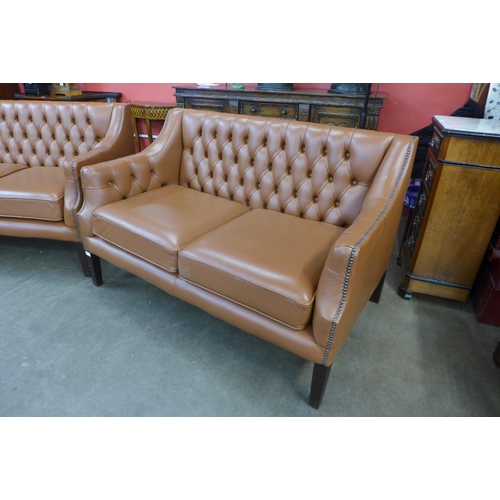 31 - A pair of mahogany and brown leather buttoned settees