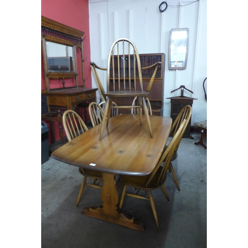 50 - An Ercol Golden Dawn elm and beech refectory table and six Quaker chairs