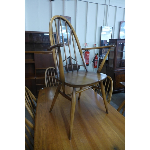 50 - An Ercol Golden Dawn elm and beech refectory table and six Quaker chairs