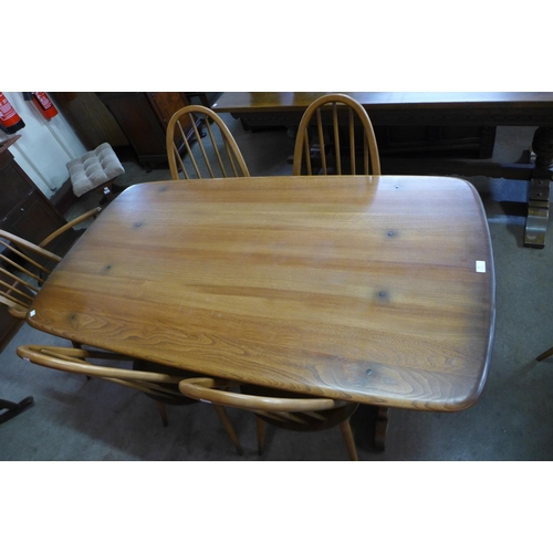 50 - An Ercol Golden Dawn elm and beech refectory table and six Quaker chairs