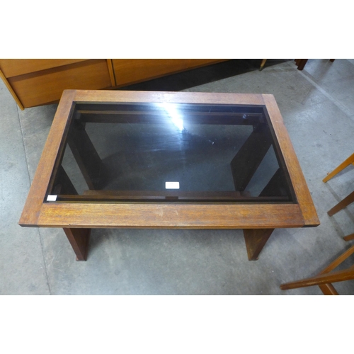 68 - A teak and glass topped coffee table