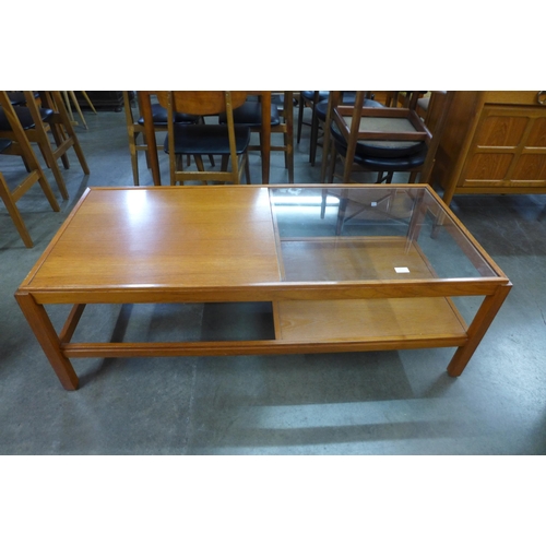 71 - A teak and glass topped coffee table