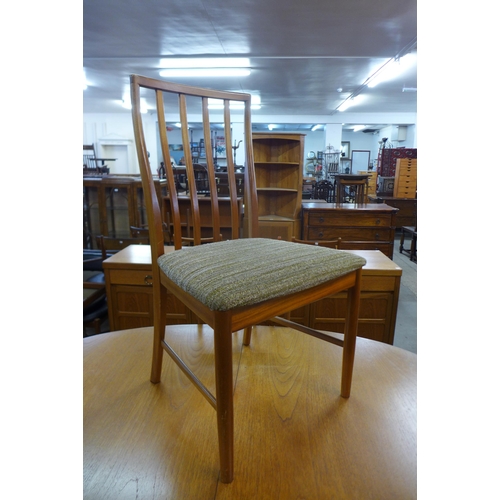 72 - A McIntosh teak extending dining table and four chairs