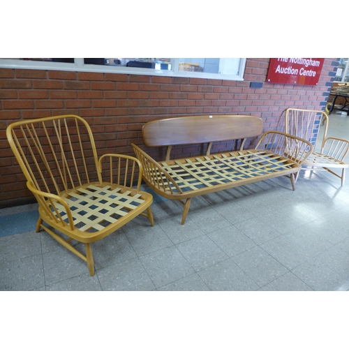 76 - An Ercol Blonde elm and beech 355 model studio couch and pair of matching armchairs