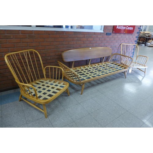 76 - An Ercol Blonde elm and beech 355 model studio couch and pair of matching armchairs