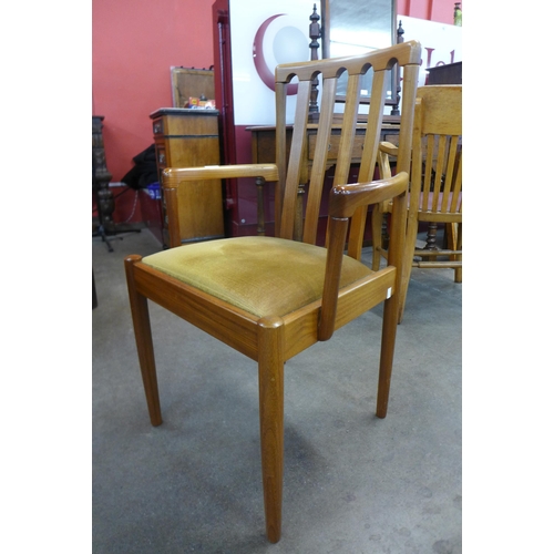 82 - A set of four teak dining chairs