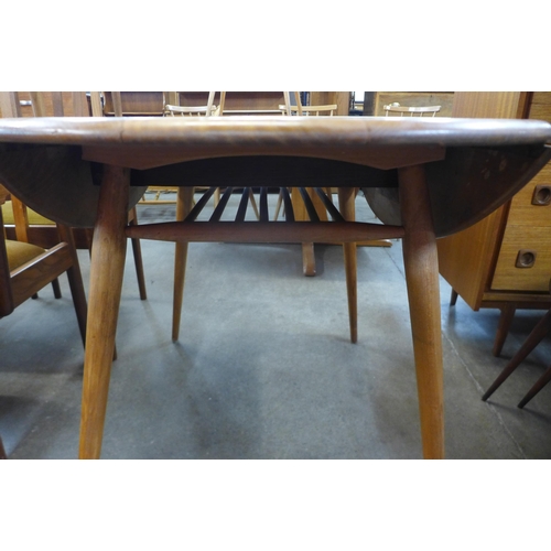 85 - An Ercol Blonde elm and beech drop-leaf table