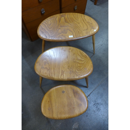 87 - An Ercol Blonde elm and beech pebble shaped nest of tables