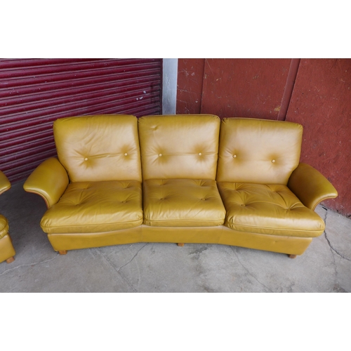 94 - A G-Plan teak and leather upholstered Tulip settee and matching armchair

* Please note this lot may... 