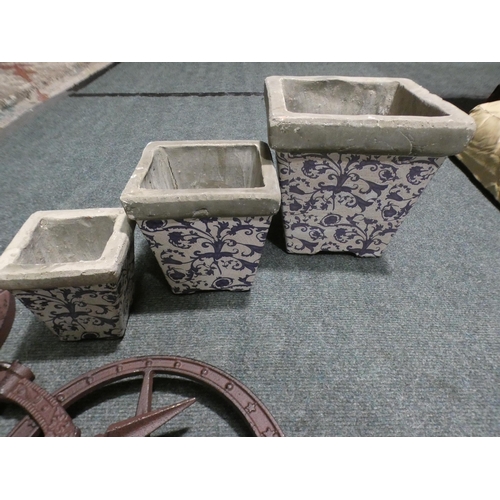 3107 - Decorative metal sundial and three concrete white and blue plant pots * This lot is subject to VAT