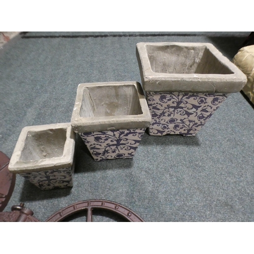 3107 - Decorative metal sundial and three concrete white and blue plant pots * This lot is subject to VAT