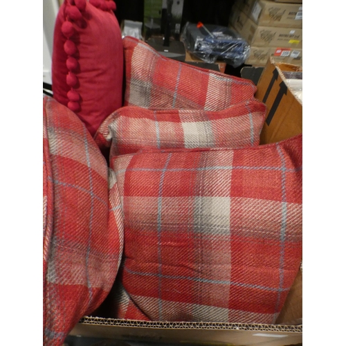 3186 - Six cushions:- set of 4 red tartan and 3 red velvet with pom poms * This lot is subject to VAT