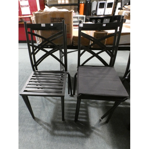 3194h - A set of four black aluminium garden chairs with 2 black cushions