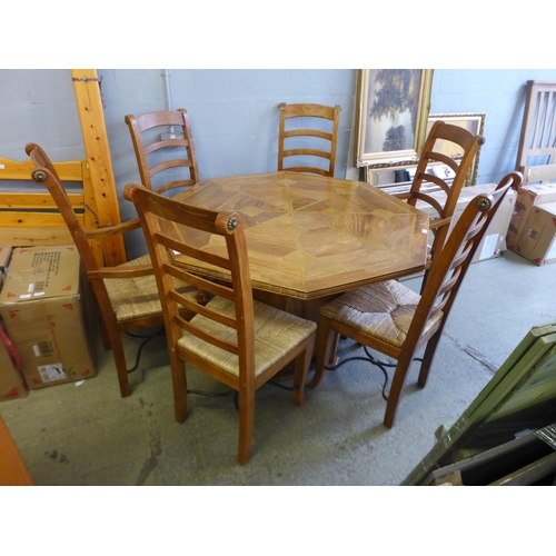 1672 - An octagonal hardwood inlaid centre dining table and six decorative ladder back chairs including two... 