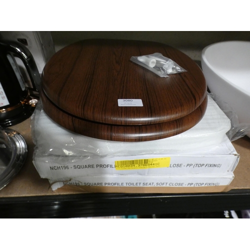 3080 - Two plastic square soft-close toilet seats and one wooden * This lot is subject to VAT