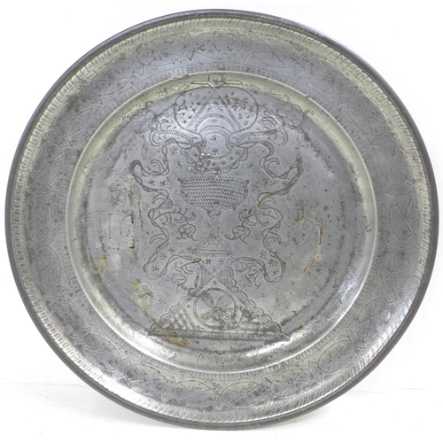 606 - A pewter wriggle work charger, dated 1691, 38.5cm