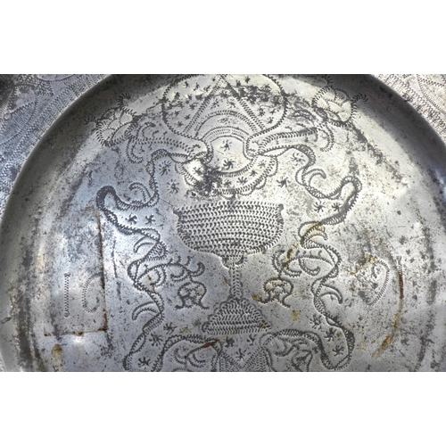 606 - A pewter wriggle work charger, dated 1691, 38.5cm