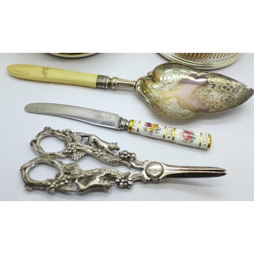 616 - A pair of plated grape scissors, two wine coasters, a server and a Royal Crown Derby knife