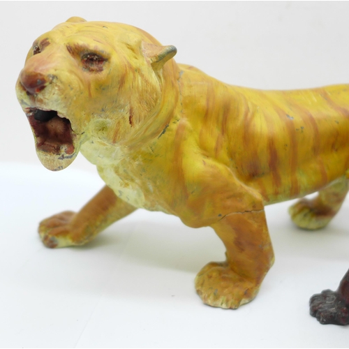 617 - Two cold painted figures of tigers, largest 23.5cm