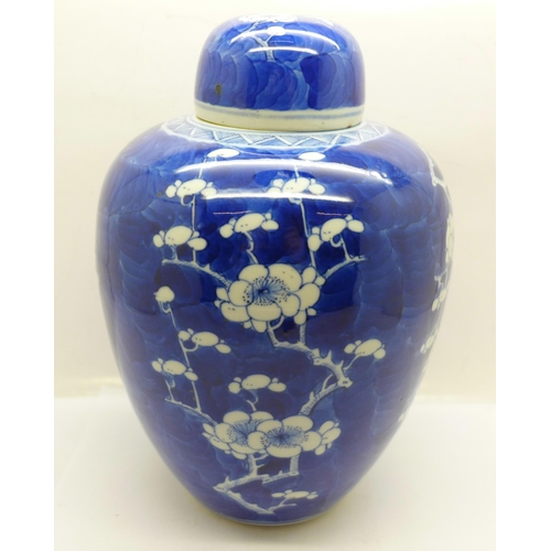 619 - A 19th Century blue and white prunus decorated ginger jar and cover, 21cm